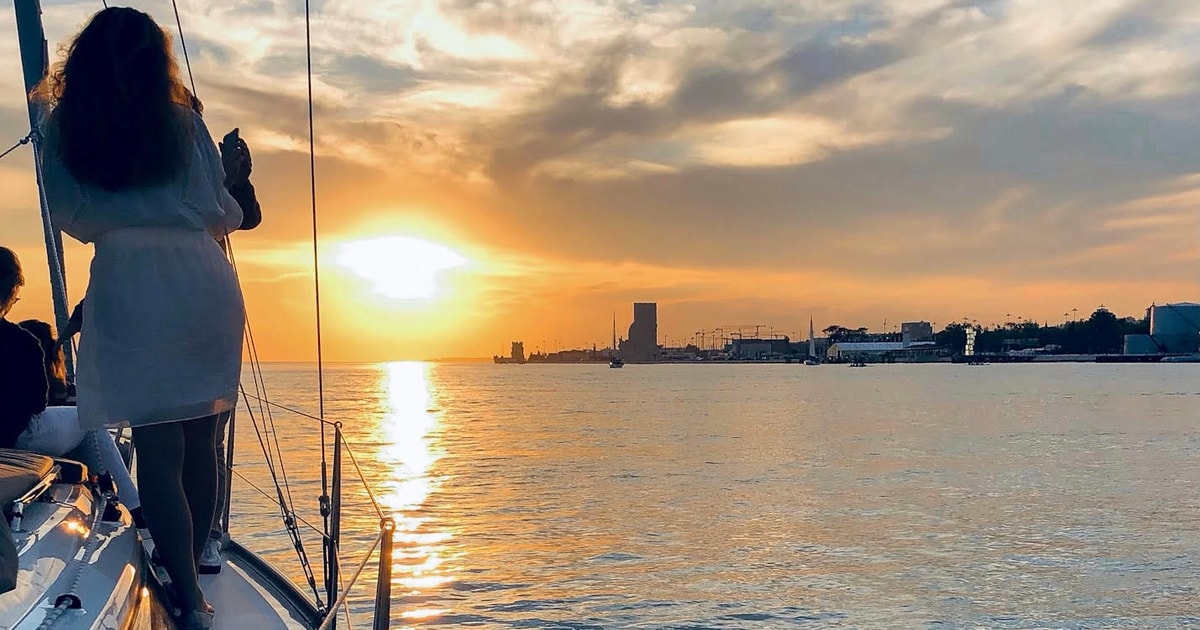 Private sailing boat on the Tagus as a couple watches the sunset
