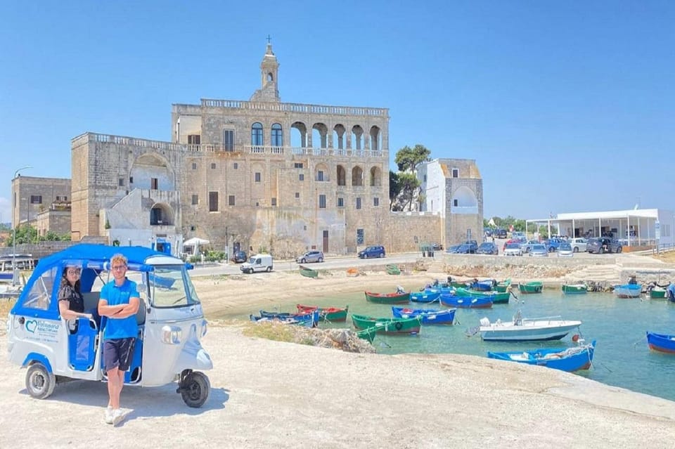 White houses of Polignano a Mare rising above the narrow cove of Lama Monachile