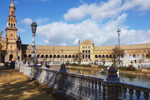 Lush gardens and palm trees at the Royal Alcázar of Seville