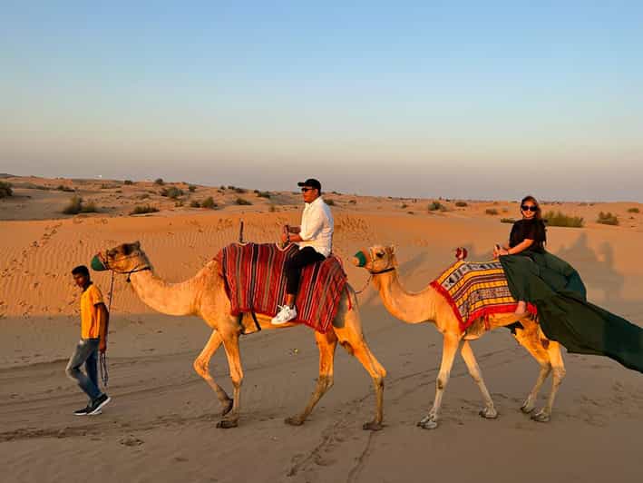 Sunset Desert Tour: Camel Ride, Sand Boarding & BBQ Dinner | GetYourGuide