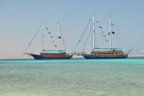 Pirates sailing Boat with white island and snorkelling