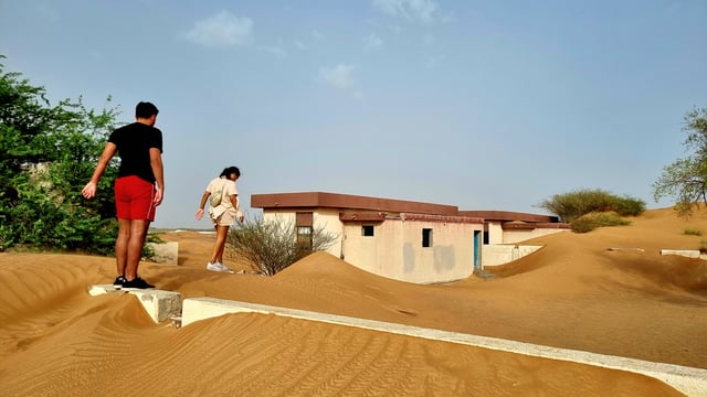 The Ghost Village Tour with Dune Bashing and Sandboarding