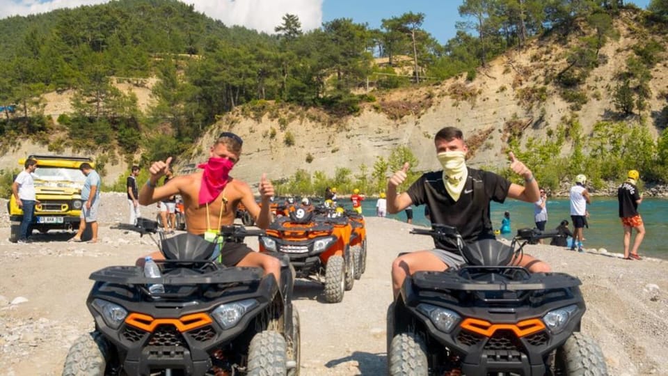 A rider on a mud-splashed quad following a forest track in the Taurus foothills