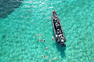 Blue lagoon with a speed boat water and towels included