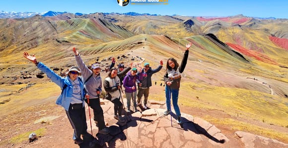 Striped highland ridges and a stone forest beneath a wide Andean sky