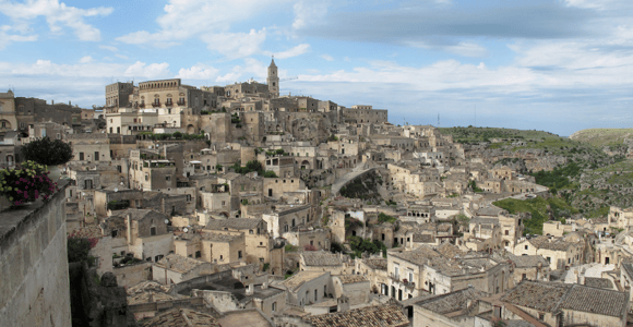 Stone houses stacked on a steep slope in the Sassi of Matera
