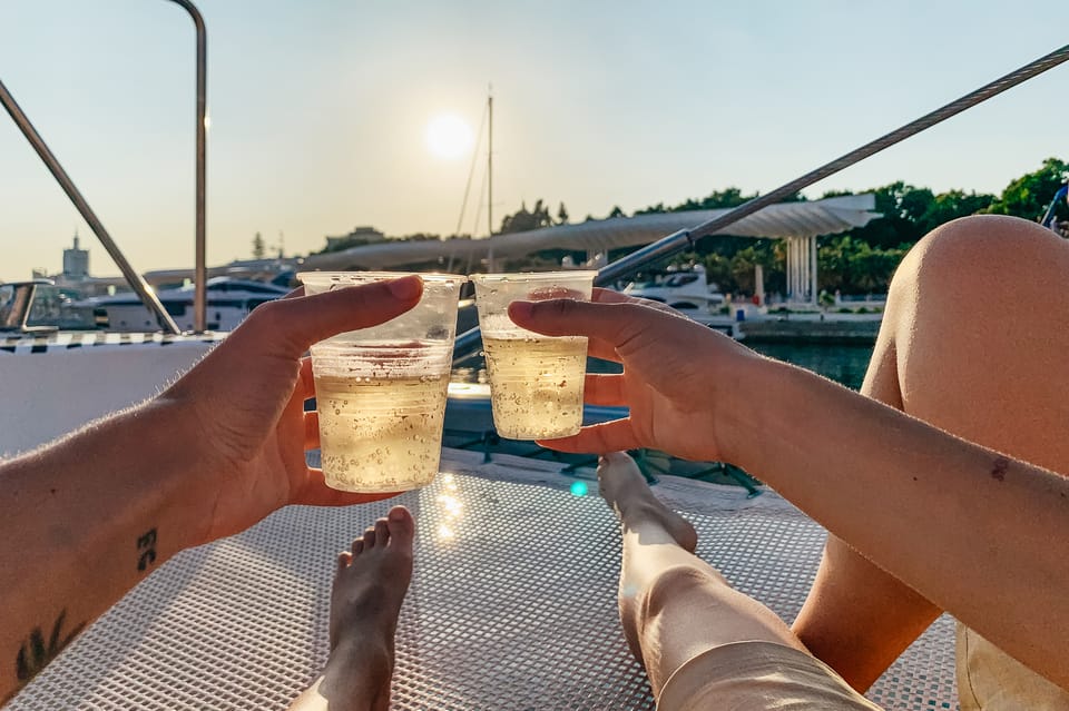 malaga sunset sailing catamaran trip with glass of cava