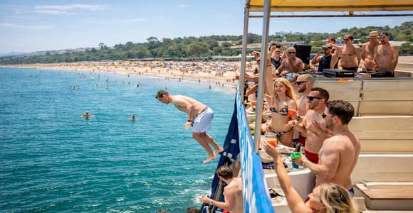 Boat Party to the Beach with Swimming Stops, DJ and Open Bar