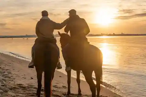 Horseback Riding on the Beach at Sunset