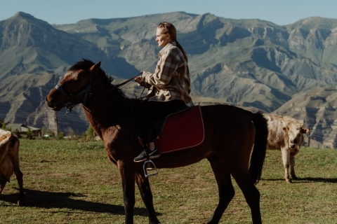 Reite auf einem Pferd zur Dreifaltigkeitskirche in Gergeti und erklimme einen Berg