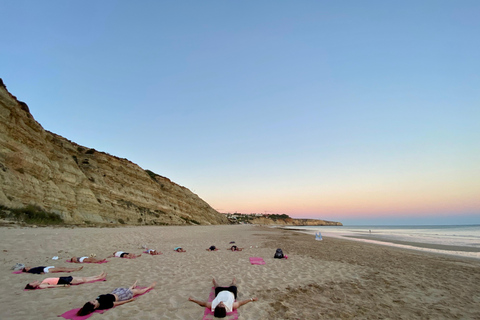 Yoga vid solnedgången på Lagos vackra strand av el Sol Lifestyle