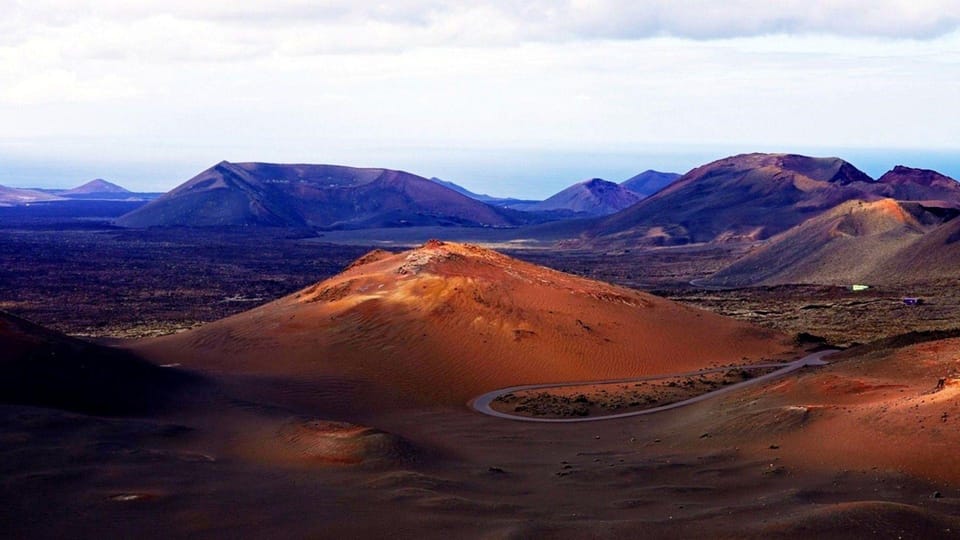 Volcanic cones and a winding road through dark lava fields
