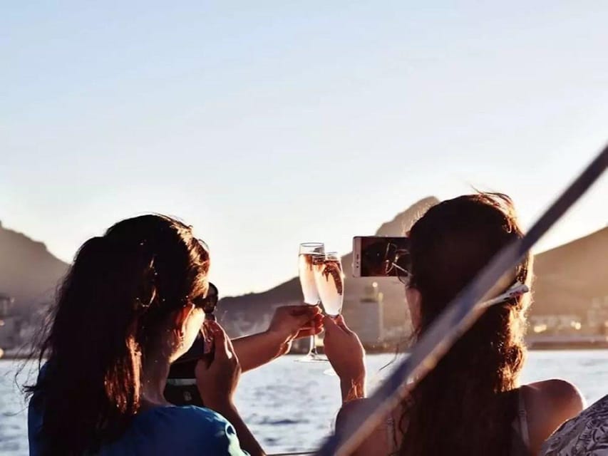 Two passengers raising glasses on a boat in the evening light