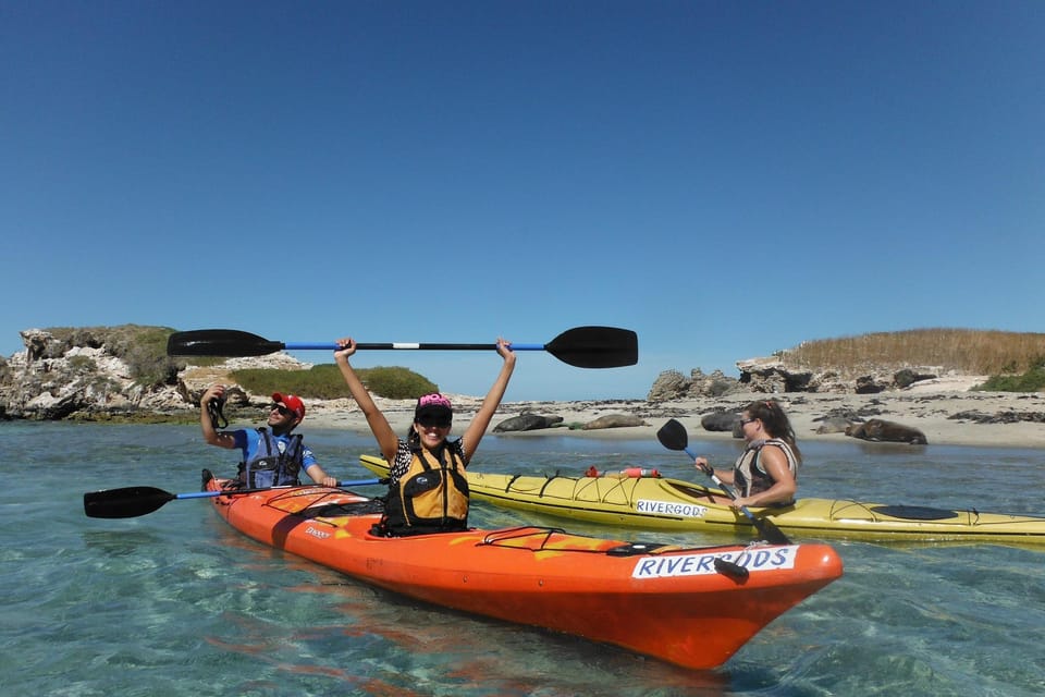 Two paddlers in a sea kayak approaching a low limestone island in Shoalwater Bay