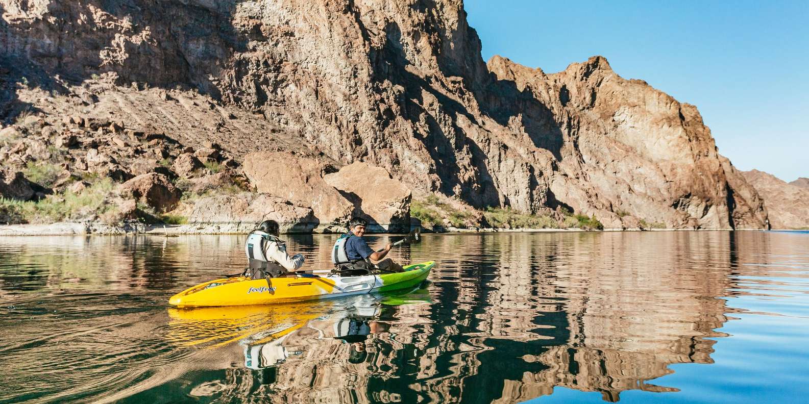 Kayaker inside Emerald Cave with green water reflection on cave ceiling