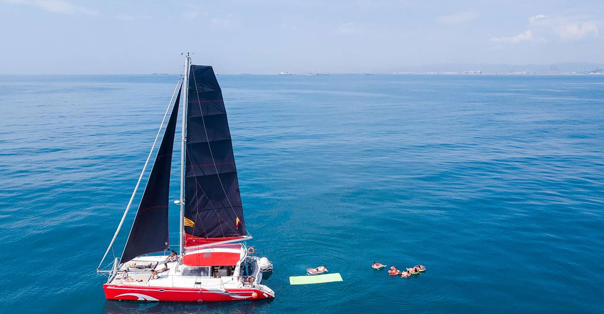 Barcelona: Sunset or Day Catamaran Cruise with Tapa & Drink photo 2