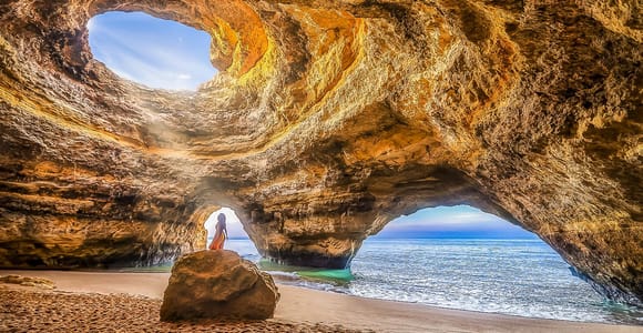 Best Benagil Cave Boat Tours (2026): Ranked, Prices & How to Book Benagil caves and Praia da Marinha seen from a boat tour at sunset