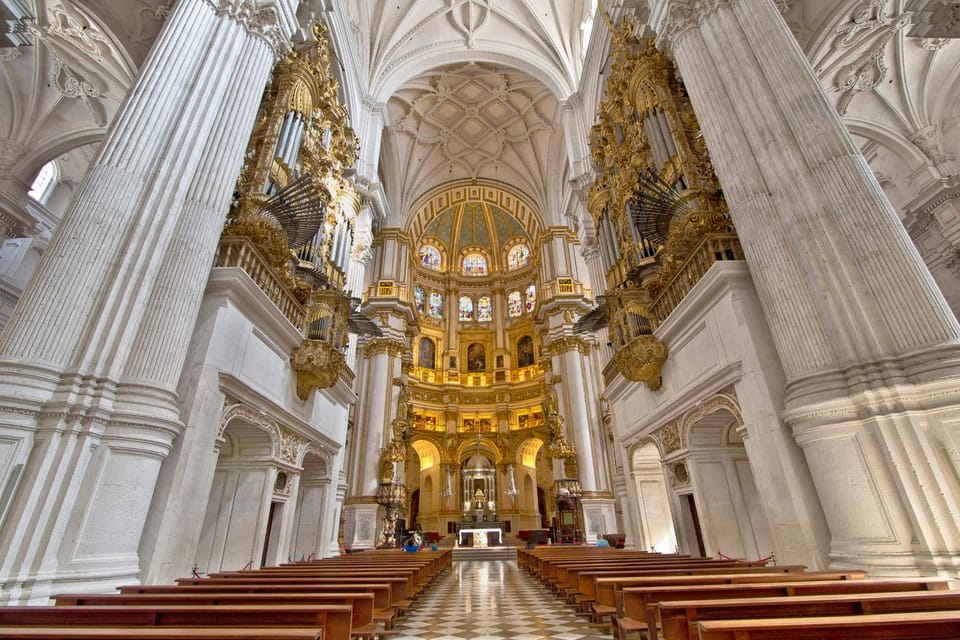 Pale stone columns and a richly decorated altar inside Granada Cathedral