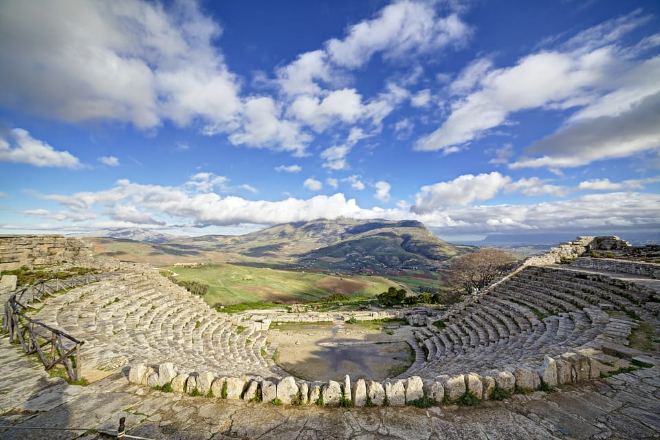 The Doric temple of Segesta standing on a green hillside beneath open sky