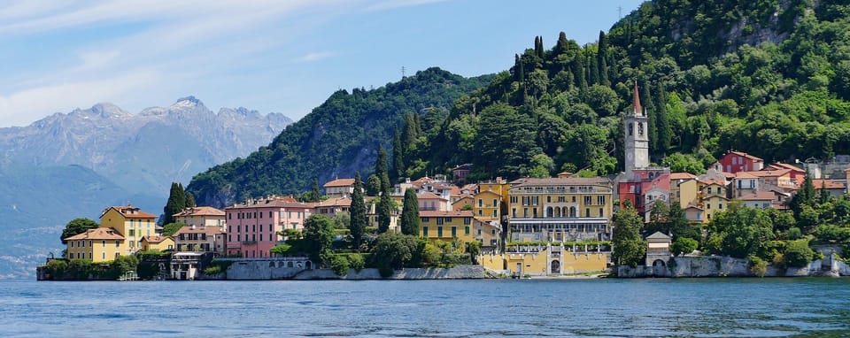 A family watching Lake Como villas from the open seating area of a passenger boat