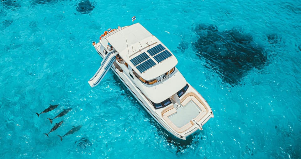 Catamaran under way between limestone islands in the Andaman Sea on a day trip from Phuket