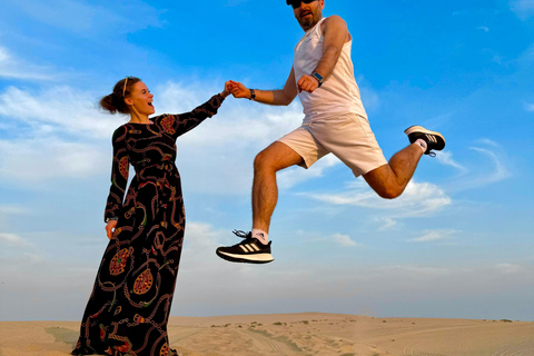 Doha: Arabic Costume, Desert Safari, Sandboarding & More Group Tour with Camel Ride in traditional Arabic Costume