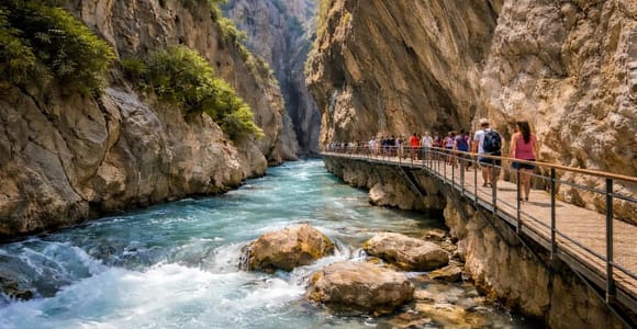 Turquoise water below the steep cliffs and roadside steps of Kaputaş Beach