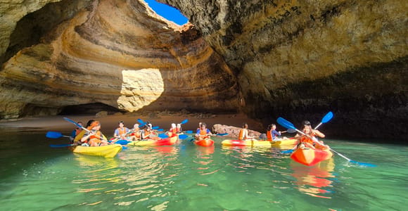 Best Benagil Cave Boat Tours (2026): Ranked, Prices & How to Book Kayakers paddling inside the Benagil cave beneath its open skylight