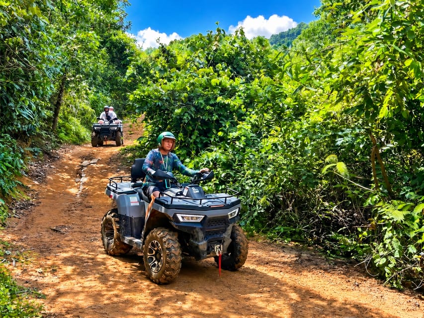 An off-road vehicle following a muddy track through dense tropical forest