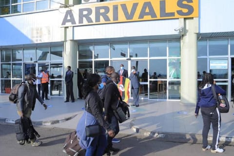 Safari vehicle driver guide holding welcome sign at airport arrival gate