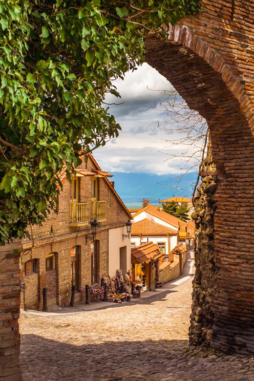 Historic stone arch and cobbled street in Sighnaghi Old Town