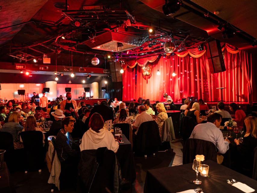 Magician performing under theatrical lights before tables in an intimate Salou venue