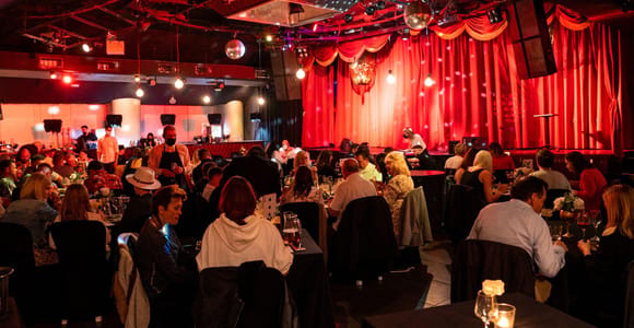 Magician performing under theatrical lights before tables in an intimate Salou venue