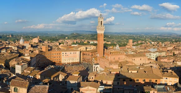 The brick Torre del Mangia rising above the shell-shaped Piazza del Campo in Siena