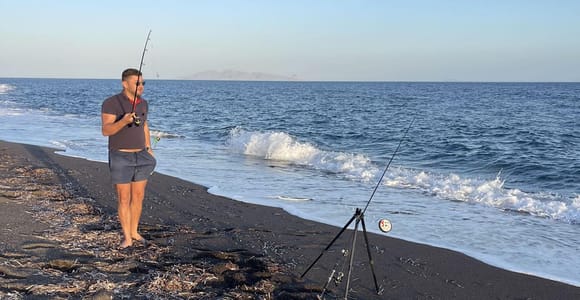 Fishing on a Peaceful Volcanic Beach in Santorini