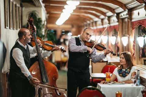 Couple enjoying Hungarian dinner and live music on a Danube cruise