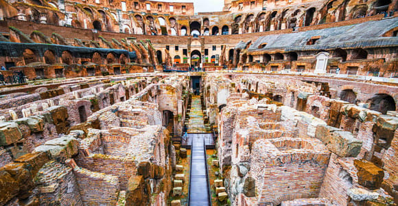 Brick corridors and vaulted chambers of the Colosseum hypogeum seen from the arena edge