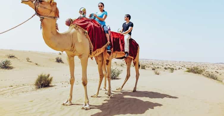 Form Dubai: Desert Safari, Camel Ride, Sandboard, BBQ & Show | GetYourGuide