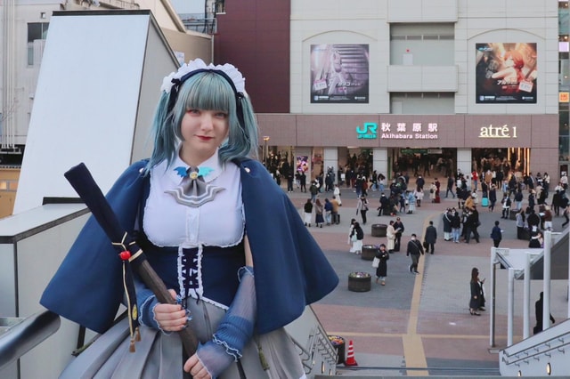 Expert Anime Guide in Akihabara with a maid witch