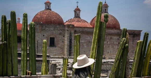 Green-stone colonial façades along a pedestrian street in Oaxaca’s historic centre