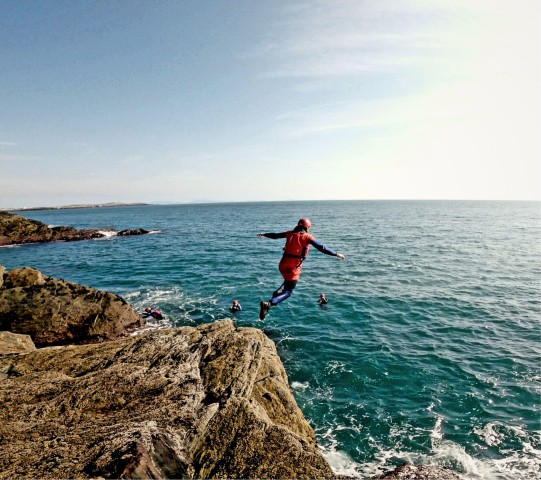 Visit Coasteering on Anglesey (cliff jumping, climbing, swimming) in Wales