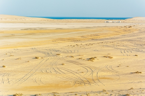 Doha: woestijnsafari zonsondergang, kameelrit en zandboardenGedeelde activiteit
