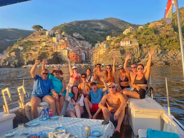 Visit CinqueTerre sunset Boat Tour with traditional ligurian gozzo in Vernazza, Italy