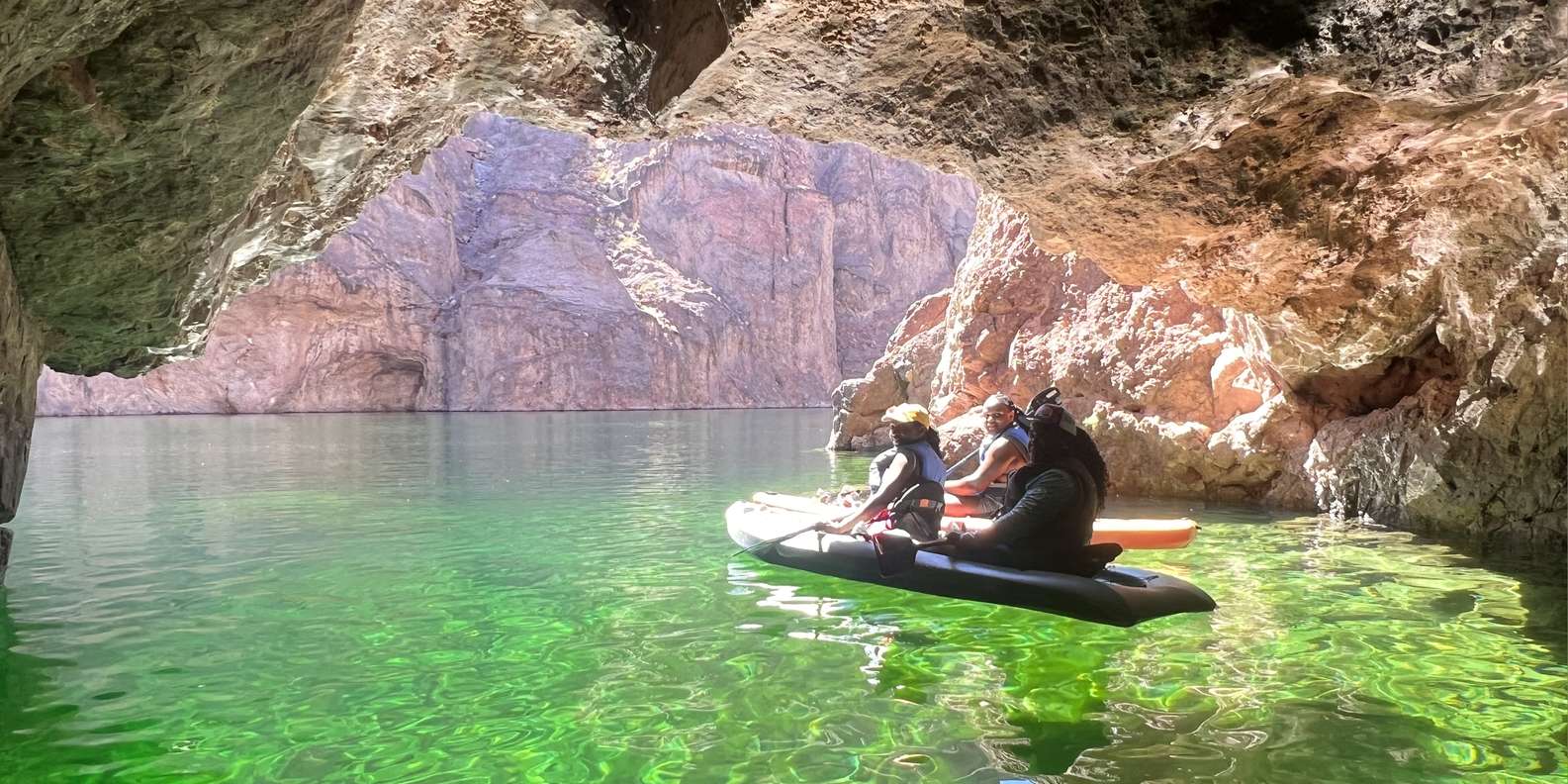 Kayaker paddling into Emerald Cave entrance, Colorado River